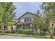 A two-story home with mixed brick and siding, complemented by mature trees and well-kept landscaping at 5892 W 94Th Pl, Westminster, CO 80031