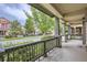 Covered front porch with railings, offering an inviting outdoor space and views of the neighborhood at 5892 W 94Th Pl, Westminster, CO 80031