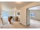 Bright and open upstairs hallway with a small table, railing and a view into an adjacent room at 5892 W 94Th Pl, Westminster, CO 80031