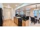 Open kitchen layout with a breakfast bar, wood cabinets, granite countertops, and stainless steel dishwasher at 5892 W 94Th Pl, Westminster, CO 80031