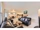 Spacious living room with plush sofas, fireplace, and an open layout leading to dining area and kitchen at 5892 W 94Th Pl, Westminster, CO 80031