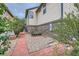 Property's side yard with brick and rock landscaping, flower bed, and brick walkway enhances outdoor aesthetics at 5892 W 94Th Pl, Westminster, CO 80031