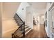 Welcoming hallway showcases hardwood floors, a staircase with wrought iron details, and neutral walls at 7120 Forest Ridge Cir, Castle Pines, CO 80108