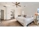 Spacious main bedroom with carpet, ceiling fan, and views to the bathroom at 7120 Forest Ridge Cir, Castle Pines, CO 80108