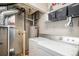 Basement laundry area featuring a washer, dryer, water heater, and shelving at 23235 York Ave, Parker, CO 80138