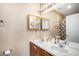 Well-lit bathroom featuring double sinks, medicine cabinet, and shower with curtain at 23235 York Ave, Parker, CO 80138