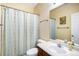 Cozy bathroom featuring shower with curtain, toilet, and vanity with large mirror at 23235 York Ave, Parker, CO 80138