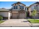 Charming two-story townhome featuring a stone facade and two-car garage at 23235 York Ave, Parker, CO 80138