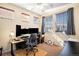 Bright home office with three monitors, multiple windows, and comfortable chair at 23235 York Ave, Parker, CO 80138