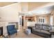 Open-concept living room with a fireplace and access to the dining room at 23235 York Ave, Parker, CO 80138