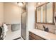 Bathroom featuring a glass-enclosed shower, vanity with wood cabinets, and modern fixtures at 10223 W 77Th Dr, Arvada, CO 80005