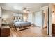 Bright bedroom with hardwood floors, ceiling fan, and a charming bed with built-in storage at 10223 W 77Th Dr, Arvada, CO 80005
