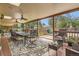 Large covered deck with ceiling fans and outdoor dining and lounge areas overlooking the backyard at 10223 W 77Th Dr, Arvada, CO 80005