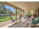 Spacious covered patio with multiple seating areas and an outdoor grill overlooking the fenced yard at 10223 W 77Th Dr, Arvada, CO 80005