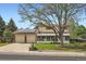 Charming two-story home with solar panels, a well-maintained lawn, and an attached two-car garage at 10223 W 77Th Dr, Arvada, CO 80005