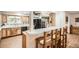 Bright kitchen with modern appliances, wooden cabinets, and a breakfast bar at 10223 W 77Th Dr, Arvada, CO 80005