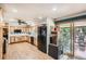 Bright kitchen with wooden cabinets, stainless steel appliances, and a sliding glass door to the deck at 10223 W 77Th Dr, Arvada, CO 80005