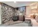 Cozy stone fireplace with a charming wood-burning stove and cushioned bench seating at 10223 W 77Th Dr, Arvada, CO 80005