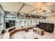 Bright sunroom featuring a ceiling fan, tile floors, and numerous windows offering ample natural light at 10223 W 77Th Dr, Arvada, CO 80005