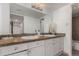 A bright bathroom featuring double sinks, granite countertops, and modern lighting at 9725 E Harvard Ave # 418, Denver, CO 80231