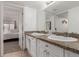 Well-lit bathroom featuring double sinks, granite countertops, and neutral décor offers a serene retreat at 9725 E Harvard Ave # 418, Denver, CO 80231