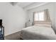 Cozy bedroom with plush carpet, soft lighting, and a large window offers comfort and relaxation at 9725 E Harvard Ave # 418, Denver, CO 80231