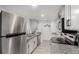 Updated kitchen with stainless steel appliances, white cabinets, and granite countertops at 9725 E Harvard Ave # 418, Denver, CO 80231