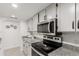 Updated kitchen with granite countertops, stainless steel appliances and white cabinets at 9725 E Harvard Ave # 418, Denver, CO 80231