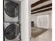 Convenient laundry area with stacked washer and dryer units near the living room at 9725 E Harvard Ave # 418, Denver, CO 80231