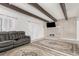 Spacious living room featuring a brick fireplace and ceiling beams, with a TV mounted above the mantel at 9725 E Harvard Ave # 418, Denver, CO 80231