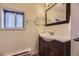 Bathroom features a vanity sink, dark wood cabinetry, and a window for natural light at 3493 S Eudora St, Denver, CO 80222