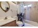 Nicely tiled bathroom features a shower-tub combination and attractive vanity area at 3493 S Eudora St, Denver, CO 80222