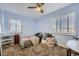 Cozy bedroom with plush carpeting, a ceiling fan, and windows providing ample natural light at 3493 S Eudora St, Denver, CO 80222