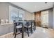 Bright dining room with modern gray walls, carpeted flooring, and a barn door that leads to the kitchen at 3493 S Eudora St, Denver, CO 80222