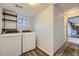 Well-lit laundry room features a washer, dryer, shelving, and wood-look flooring at 3493 S Eudora St, Denver, CO 80222