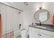 This bathroom features a shower-tub combo, dark fixtures, grey counters and white shaker cabinets at 16722 Shoshone St, Broomfield, CO 80023
