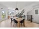 Bright dining area with wood table and staircase access at 16722 Shoshone St, Broomfield, CO 80023