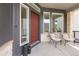 Inviting front porch with seating, stone accents, and a vibrant red door creates a warm welcome at 16722 Shoshone St, Broomfield, CO 80023