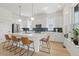 Bright kitchen featuring quartz countertops, an island with seating, and modern appliances for cooking enjoyment at 16722 Shoshone St, Broomfield, CO 80023