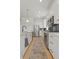 Galley kitchen features stainless steel appliances and white cabinetry at 16722 Shoshone St, Broomfield, CO 80023