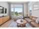 Comfortable living room with large windows, a leather sofa, and stylish decor at 16722 Shoshone St, Broomfield, CO 80023