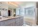 Bright bathroom features a large double vanity, soaking tub, and updated fixtures at 4276 S Tempe Ct, Aurora, CO 80018
