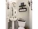Charming bathroom with decorative shelves, a pedestal sink, and toilet with decor at 4276 S Tempe Ct, Aurora, CO 80018