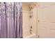 Bathroom features a white tiled shower and bathtub with a lavender shower curtain at 4276 S Tempe Ct, Aurora, CO 80018