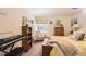 Cozy bedroom with yellow bedding, a sitting chair, and an electronic keyboard on the side at 4276 S Tempe Ct, Aurora, CO 80018