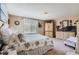 Bright bedroom with a full bed, matching dressers, and a sunny window at 4276 S Tempe Ct, Aurora, CO 80018