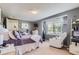 Bright bedroom with a soft chair, a bed, and a window at 4276 S Tempe Ct, Aurora, CO 80018