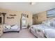 Comfortable bedroom featuring a cozy chaise lounge and plush floral bedding at 4276 S Tempe Ct, Aurora, CO 80018