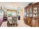 Elegant dining room features a chandelier, a large china cabinet, and hardwood floors at 4276 S Tempe Ct, Aurora, CO 80018