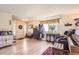 Open entryway with light wood floors and a decorative cabinet and coat rack at 4276 S Tempe Ct, Aurora, CO 80018